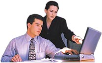 employees looking at laptop screen
